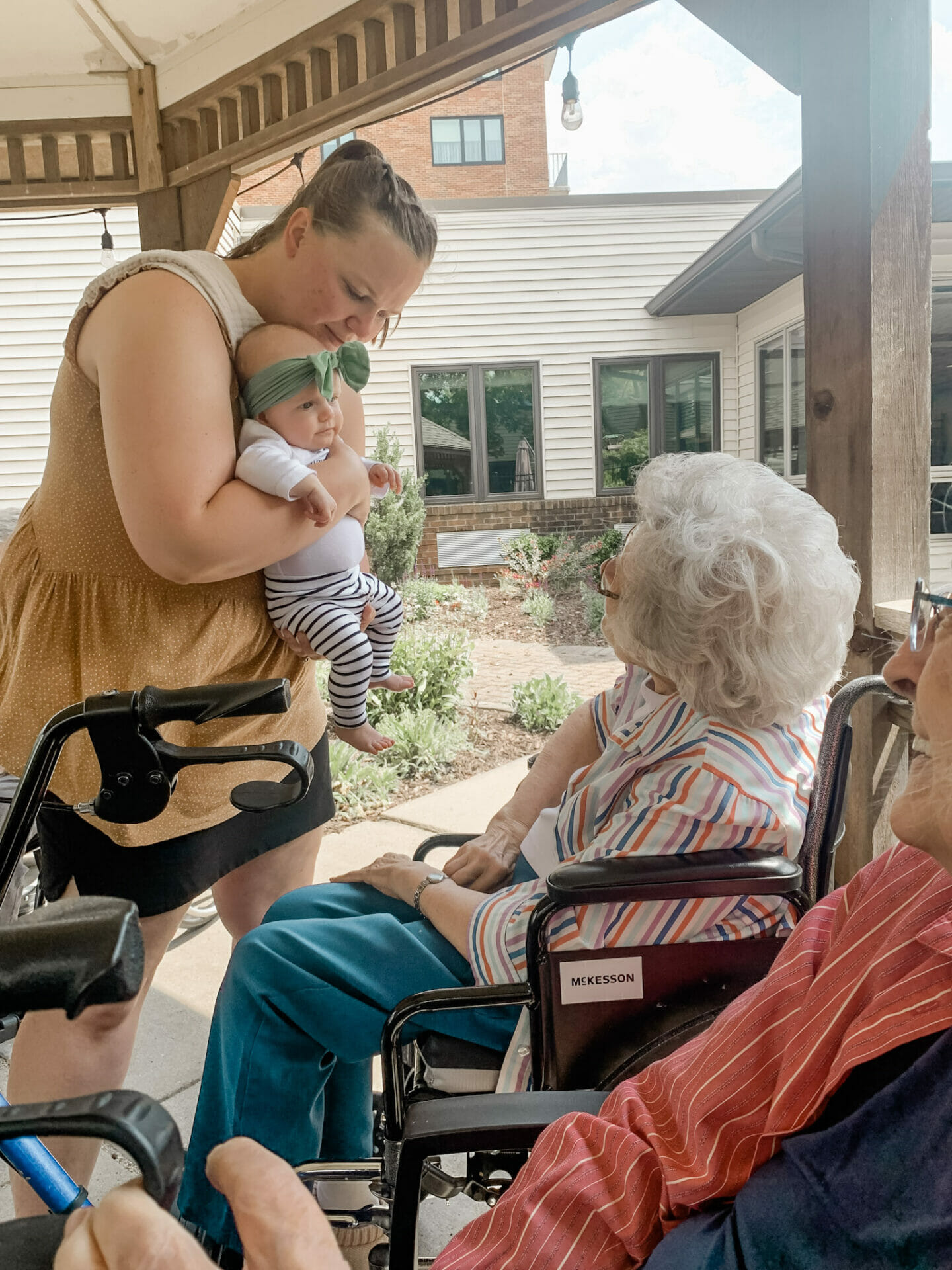 senior woman being shown a small baby