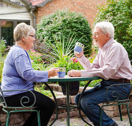senior couple enjoying coffee outside
