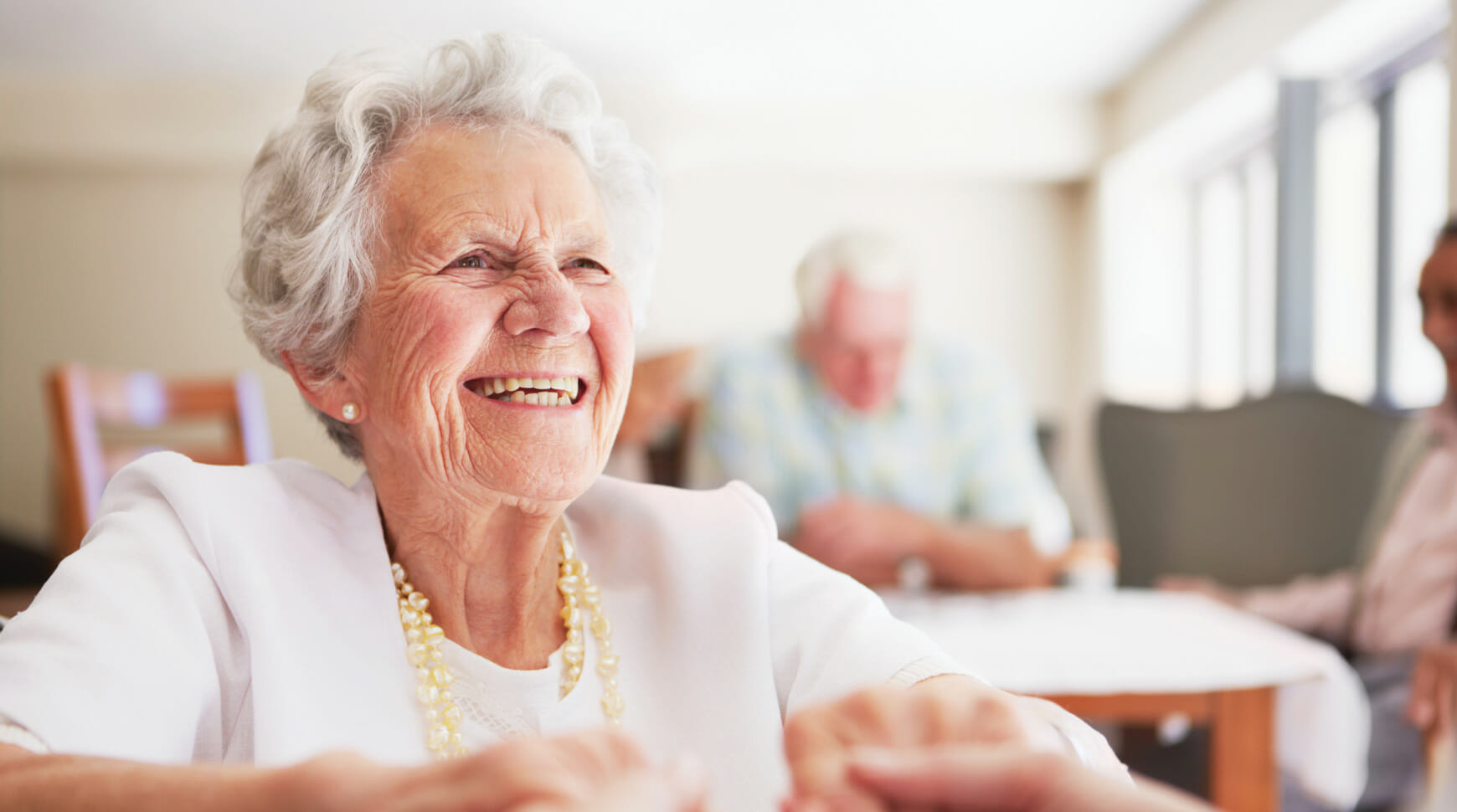 senior smiling and holding hands