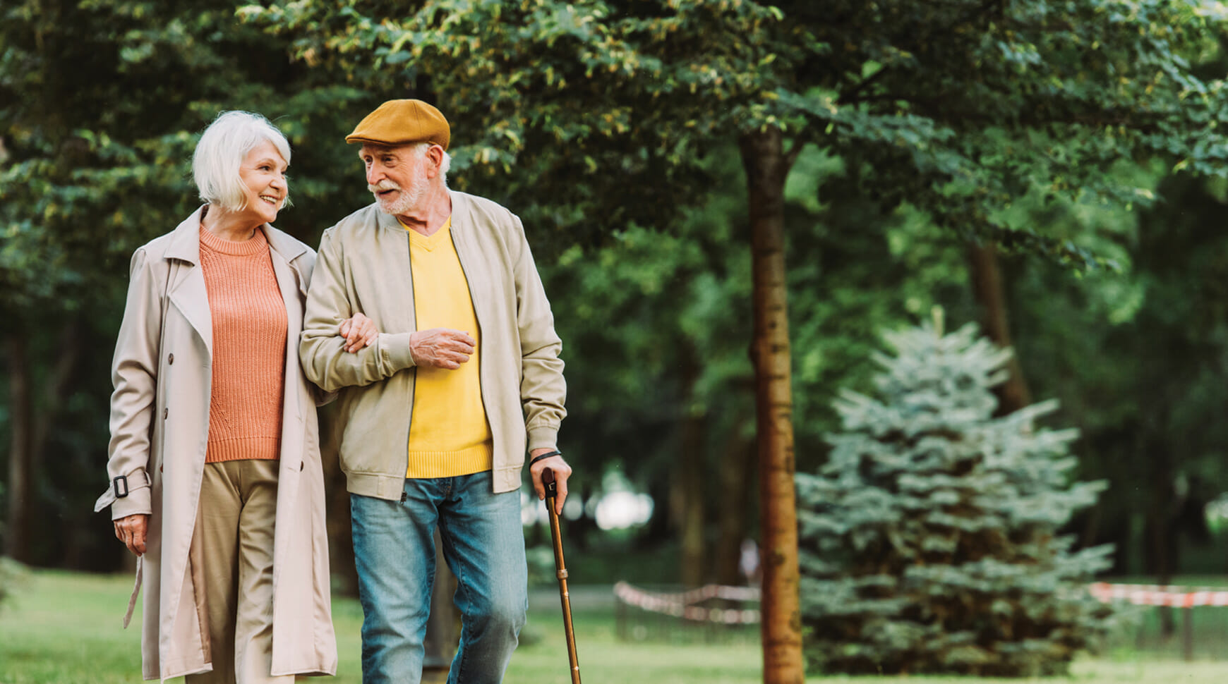 seniors walking with a cane and arms locked