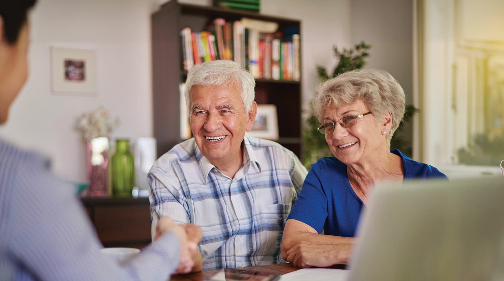 Leadership member shaking hand with senior couple